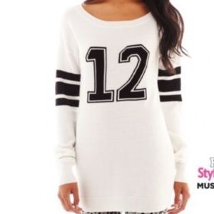 White sweater with black number and stripe detail